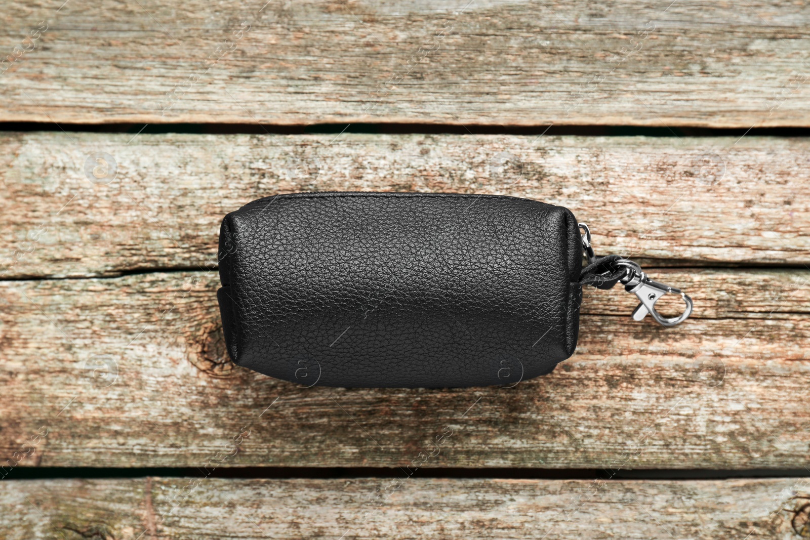 Photo of Stylish leather keys holder on old wooden table, top view