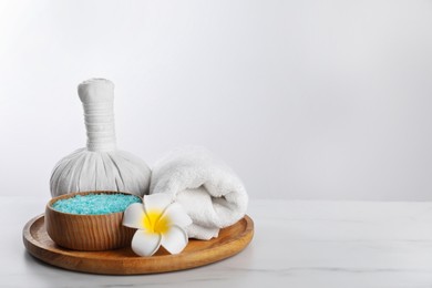 Photo of Spa composition with care products on white marble table. Space for text