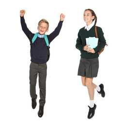 Children in school uniform jumping on white background