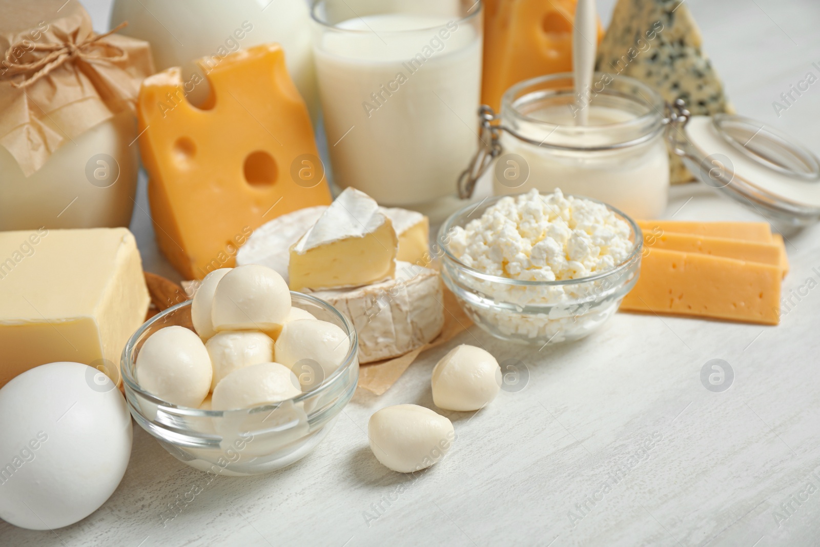 Photo of Different delicious dairy products on white table