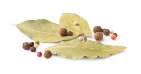 Aromatic bay leaves and peppercorns on white background