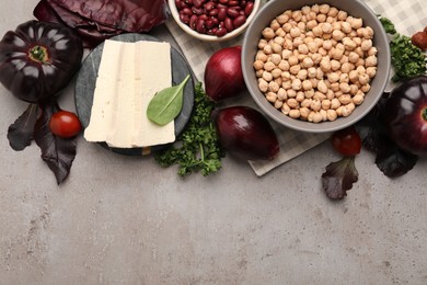 Photo of Tofu cheese and different vegetables on grey table, flat lay with space for text. Vegan diet