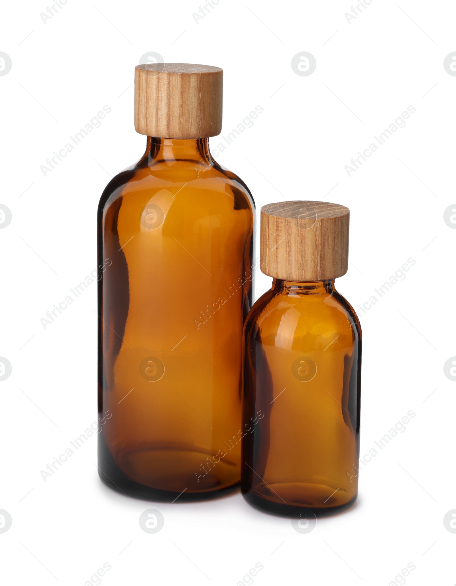 Photo of New empty glass bottles with wooden caps isolated on white