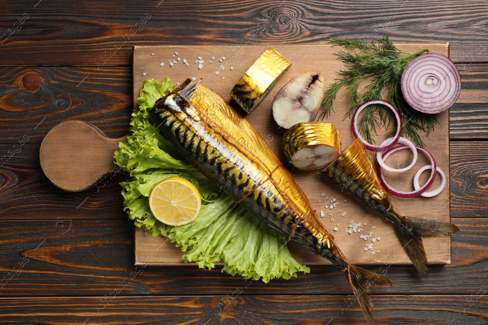 Photo of Tasty smoked fish on wooden table, top view