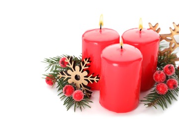 Photo of Burning red candles with Christmas decor isolated on white