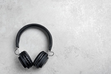 Photo of Stylish headphones on grey background, top view. Space for text