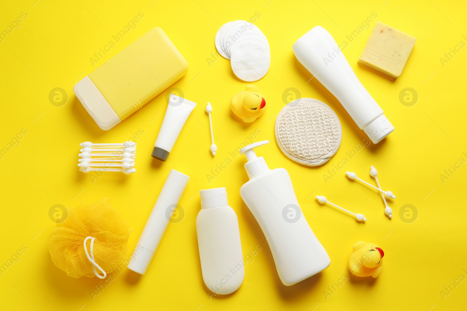 Photo of Flat lay composition with baby cosmetic products on yellow background