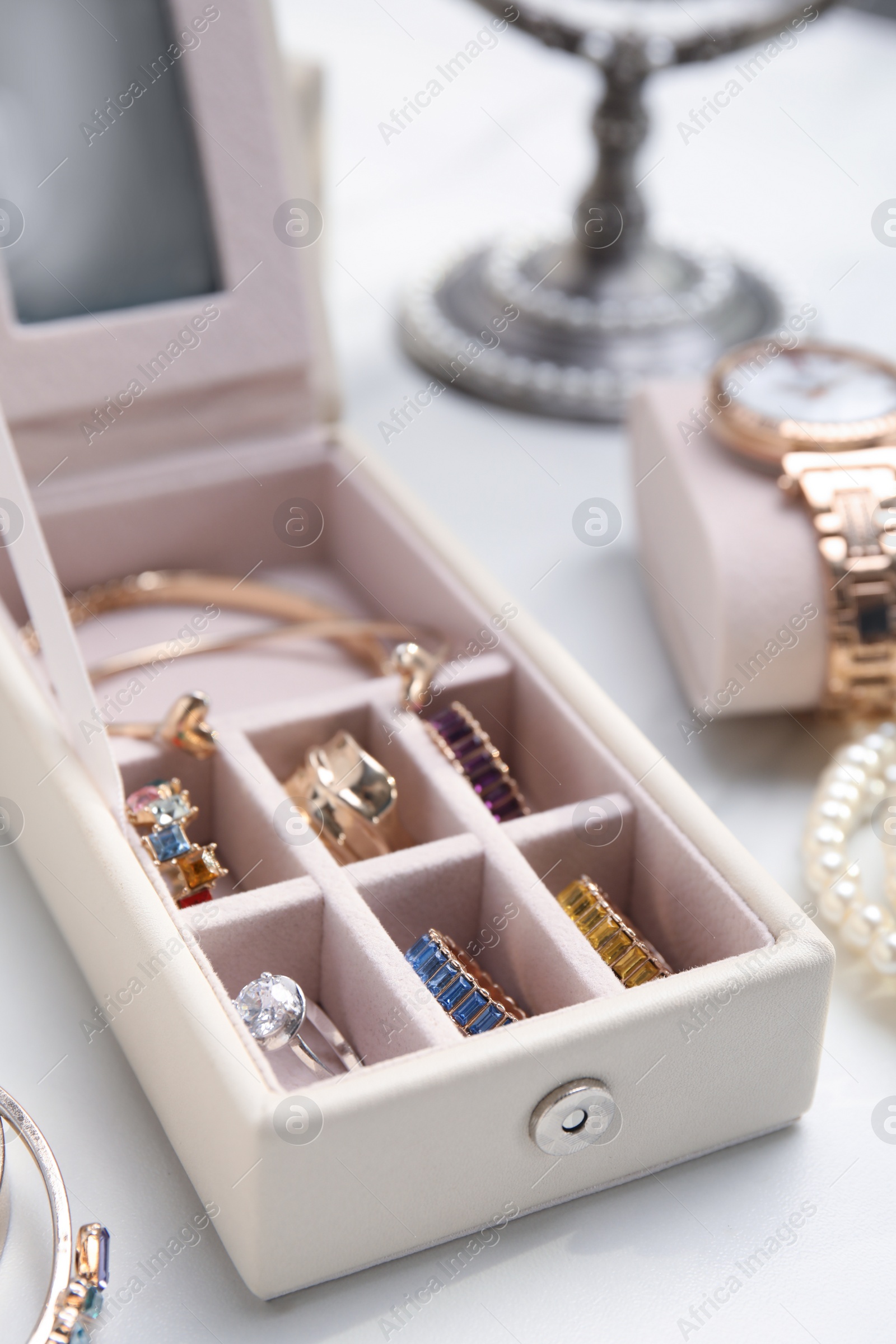 Photo of Jewelry box with stylish golden bijouterie on white table