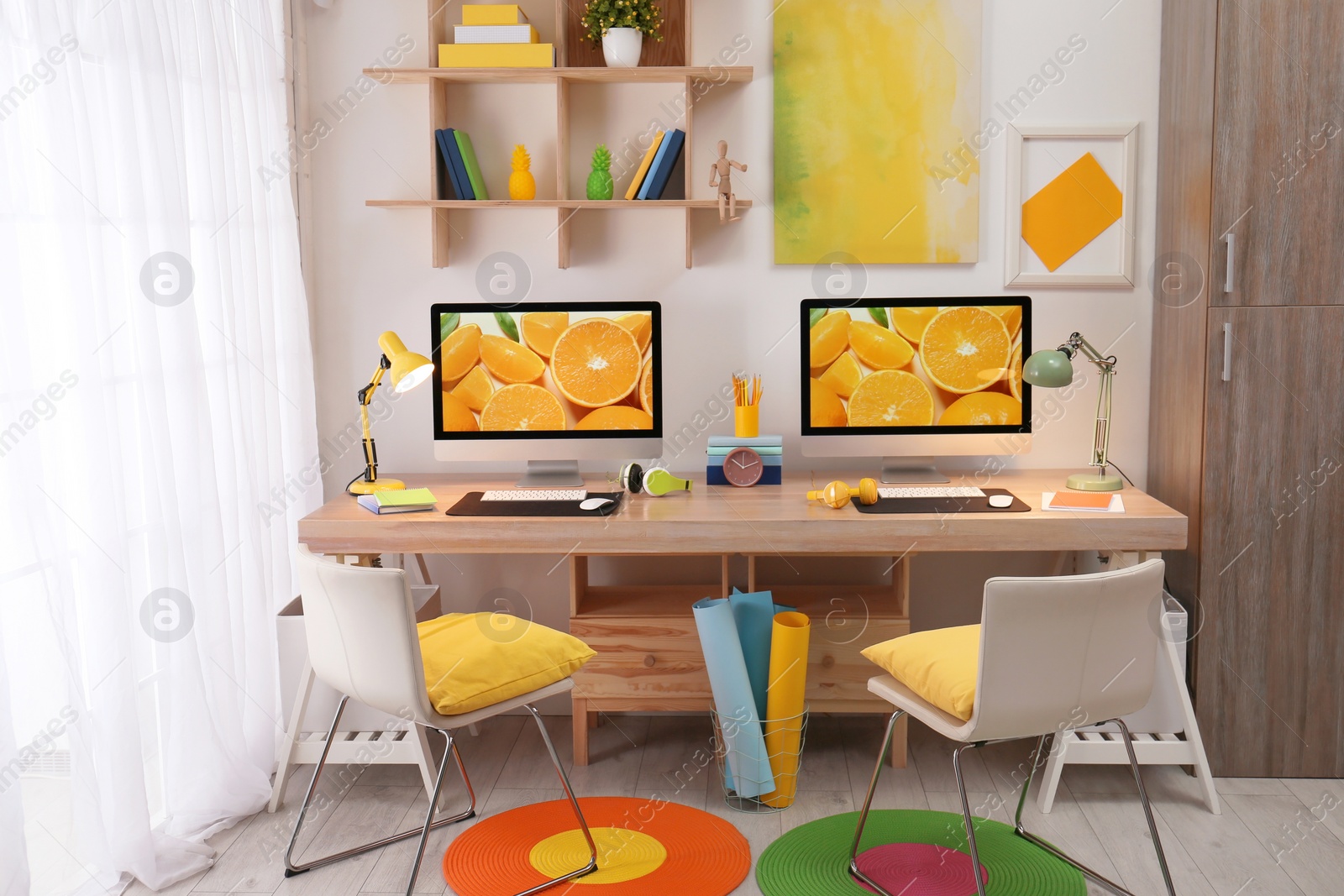 Photo of Modern workplace with large desk and computers in room. Stylish interior