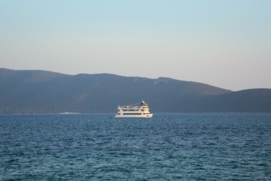 Photo of Picturesque view of calm sea with small ferry