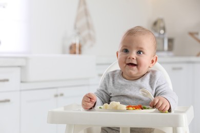 Cute little baby eating healthy food at home. Space for text