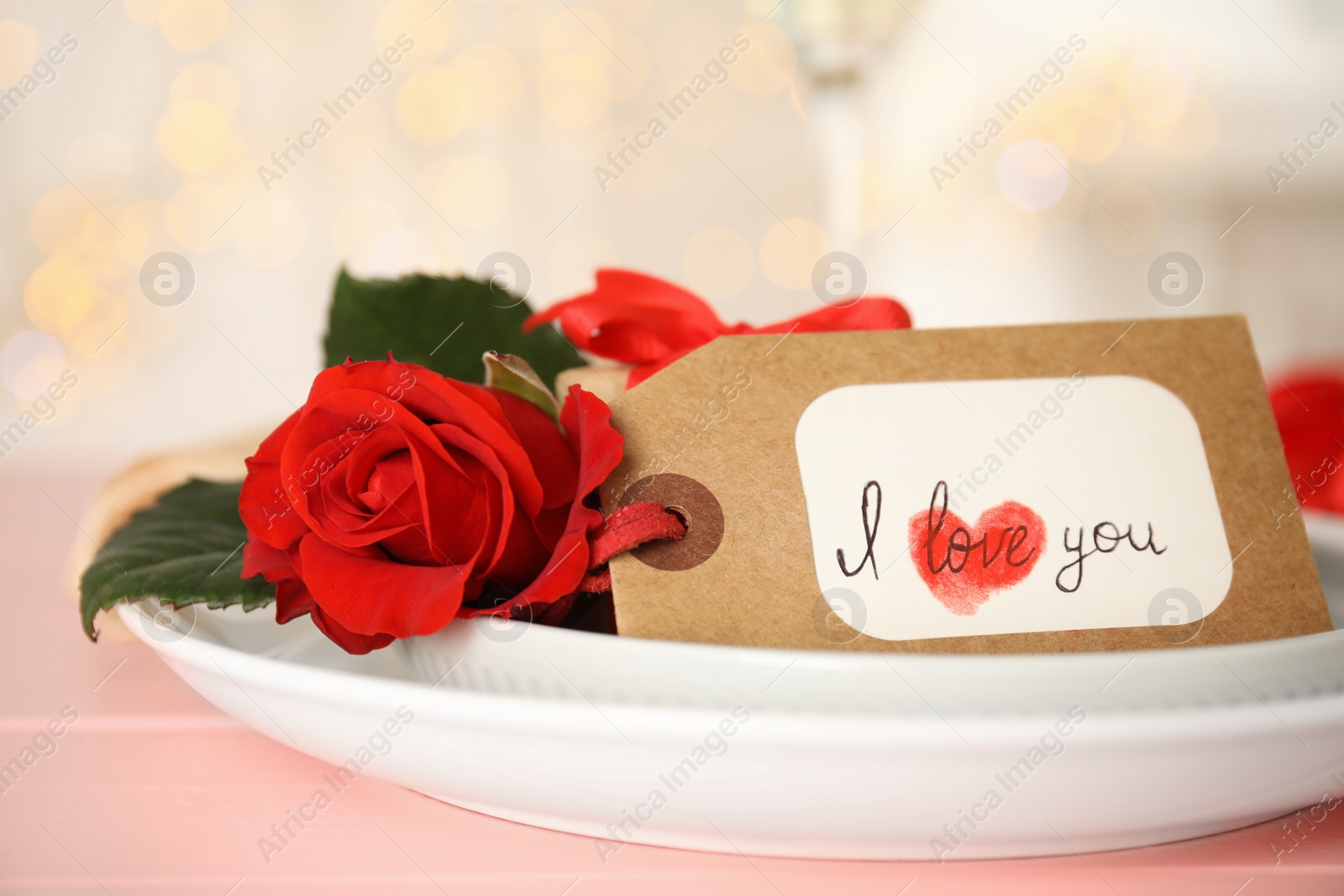 Photo of Elegant place setting for romantic dinner on pink table, closeup. Valentine's day celebration