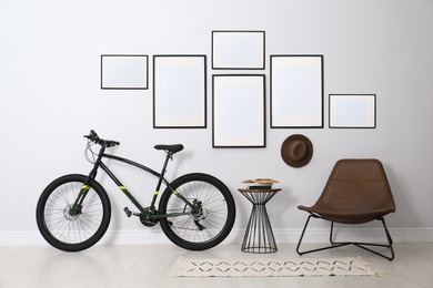 Image of Stylish room interior with empty posters on light wall. Mockup for design