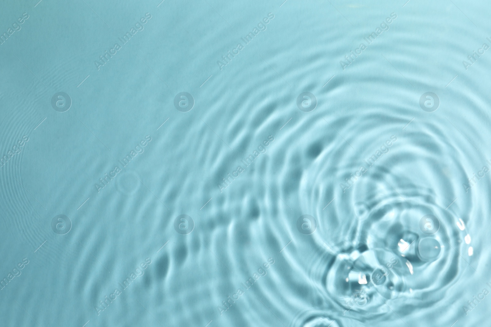 Photo of Closeup view of water with circles on turquoise background