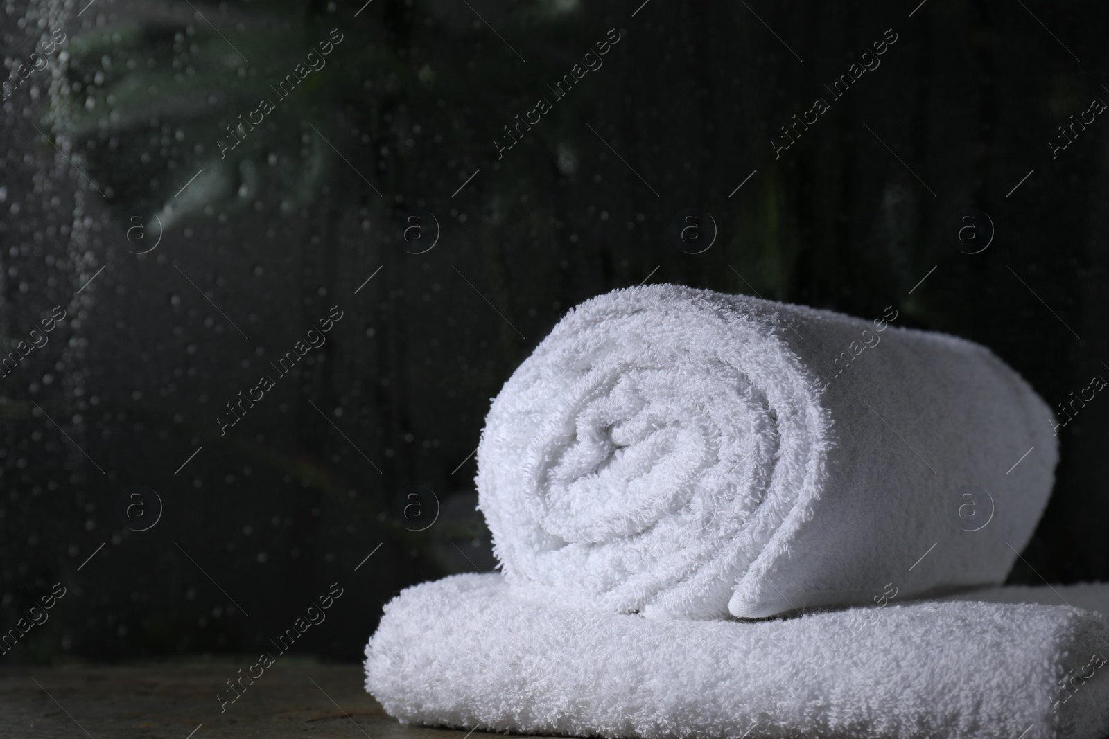 Photo of White terry towels on table in bathroom, space for text