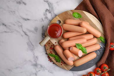 Photo of Delicious boiled sausages with spices, sauce and tomatoes on white marble table, flat lay. Space for text