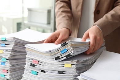 Woman working with documents in office, closeup