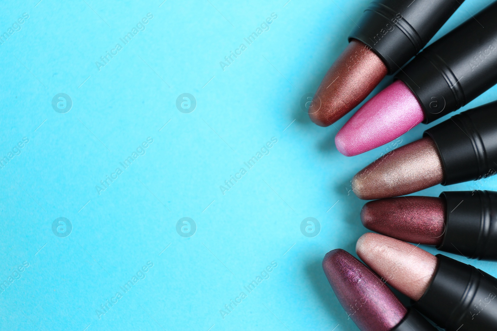 Photo of Flat lay composition with different stylish lipsticks on color background, space for text