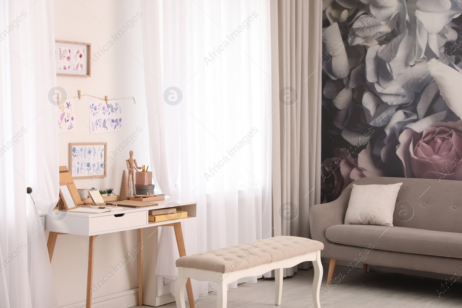 Photo of Stylish room interior with creative workplace near white wall