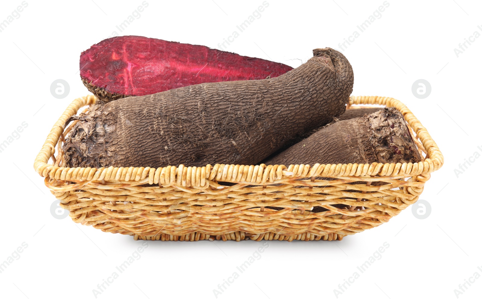 Photo of Whole and cut red beets in wicker basket isolated on white