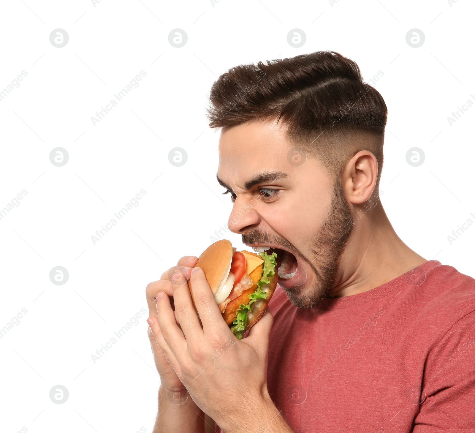 Photo of Handsome man eating tasty burger isolated on white