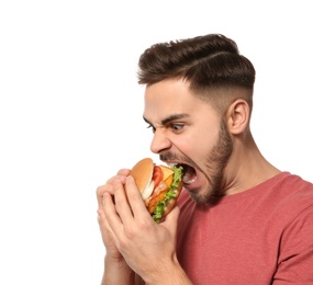 Handsome man eating tasty burger isolated on white