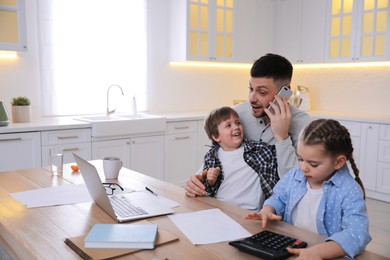 Happy man combining parenting and work at home