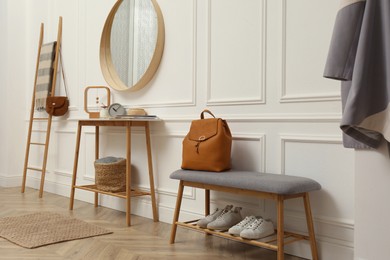 Hallway interior with stylish furniture, clothes and accessories