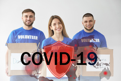 Image of Volunteers uniting to help during COVID-19 outbreak. Group of people with donations on light background, shield and world map illustrations