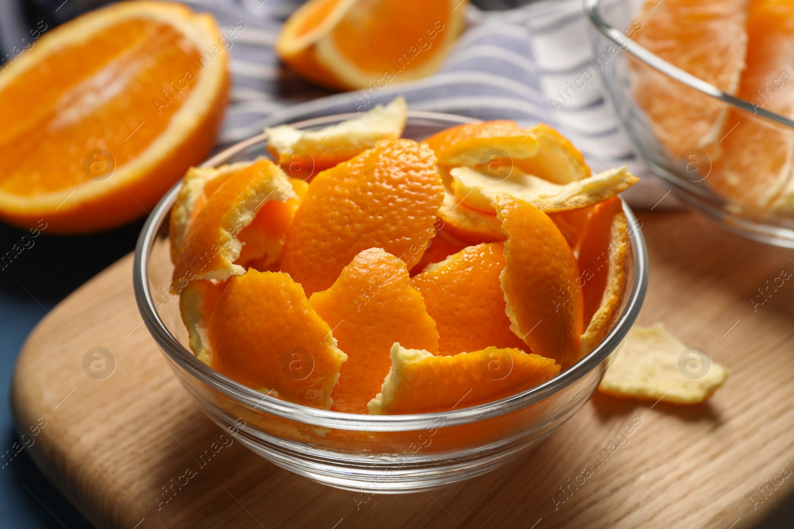 Photo of Orange peels preparing for drying and fresh fruits on table, closeup