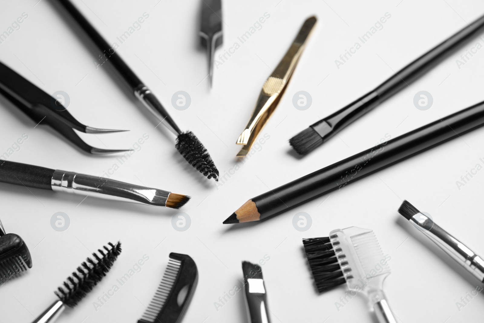 Photo of Set of professional eyebrow tools on white background