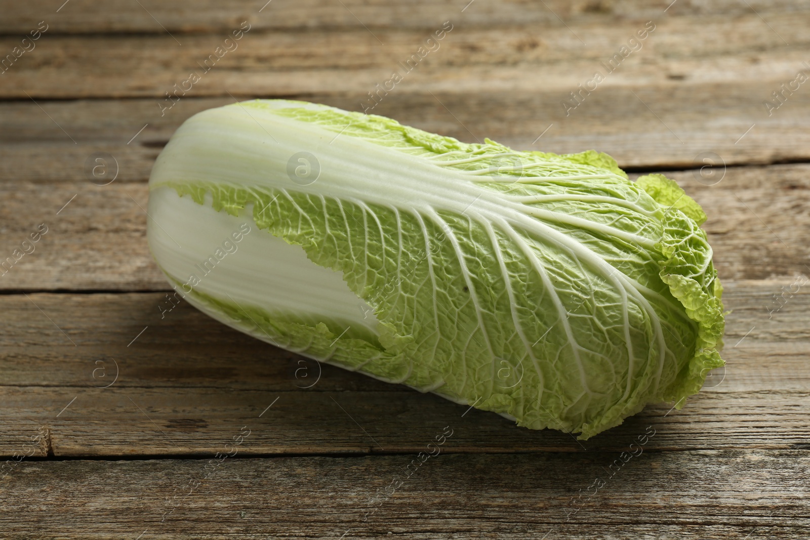 Photo of Fresh ripe Chinese cabbage on wooden table