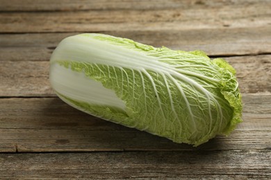 Photo of Fresh ripe Chinese cabbage on wooden table