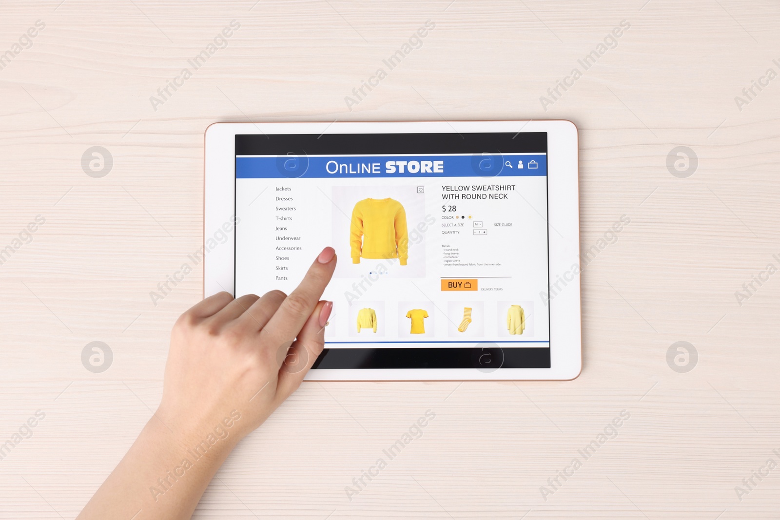 Photo of Woman with tablet shopping online at white wooden table, top view