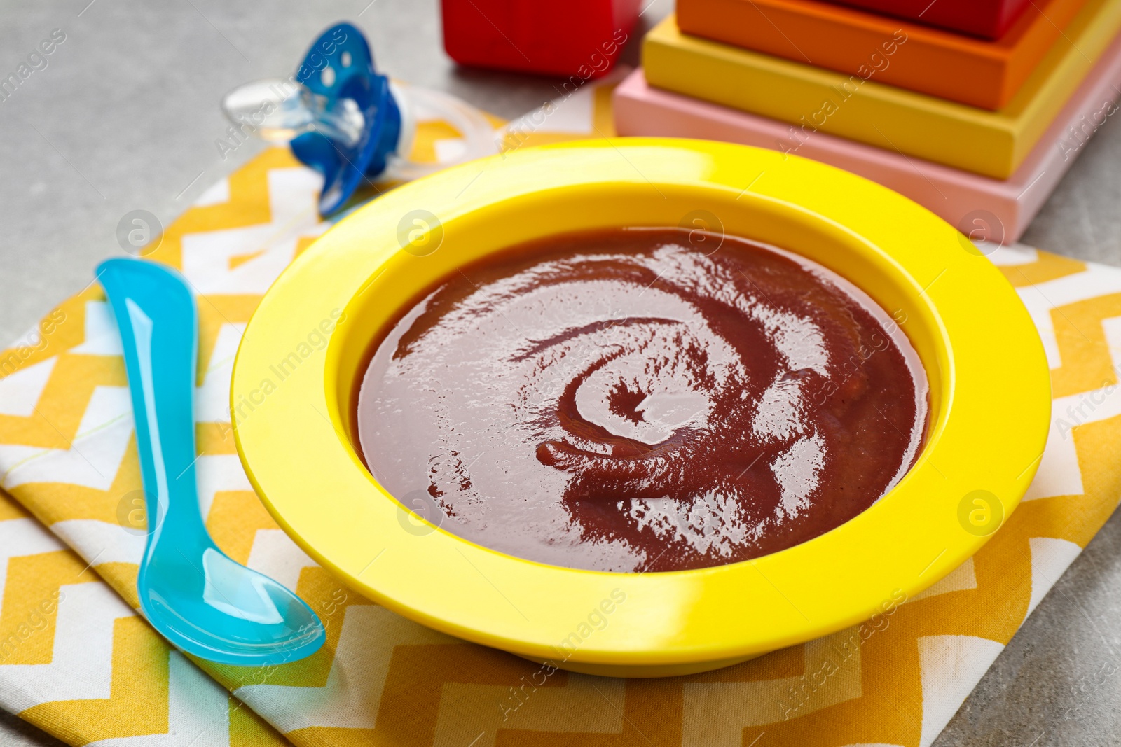 Photo of Healthy baby food in bowl on table, closeup