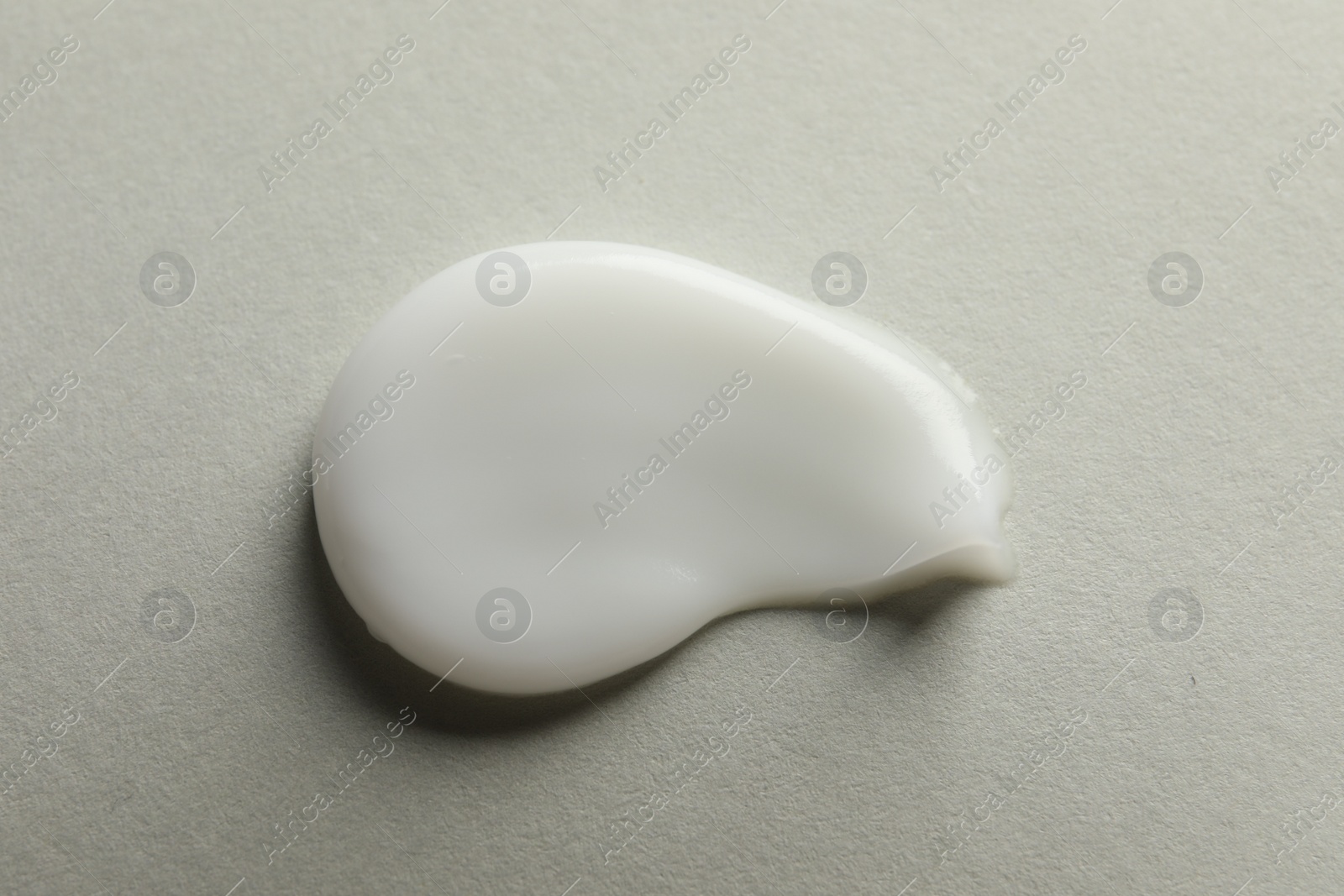 Photo of Sample of face cream on light background, top view