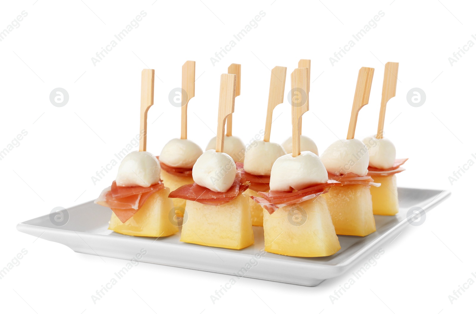 Photo of Plate with melon, mozzarella and prosciutto skewers on white background