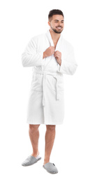 Handsome man wearing bathrobe on white background