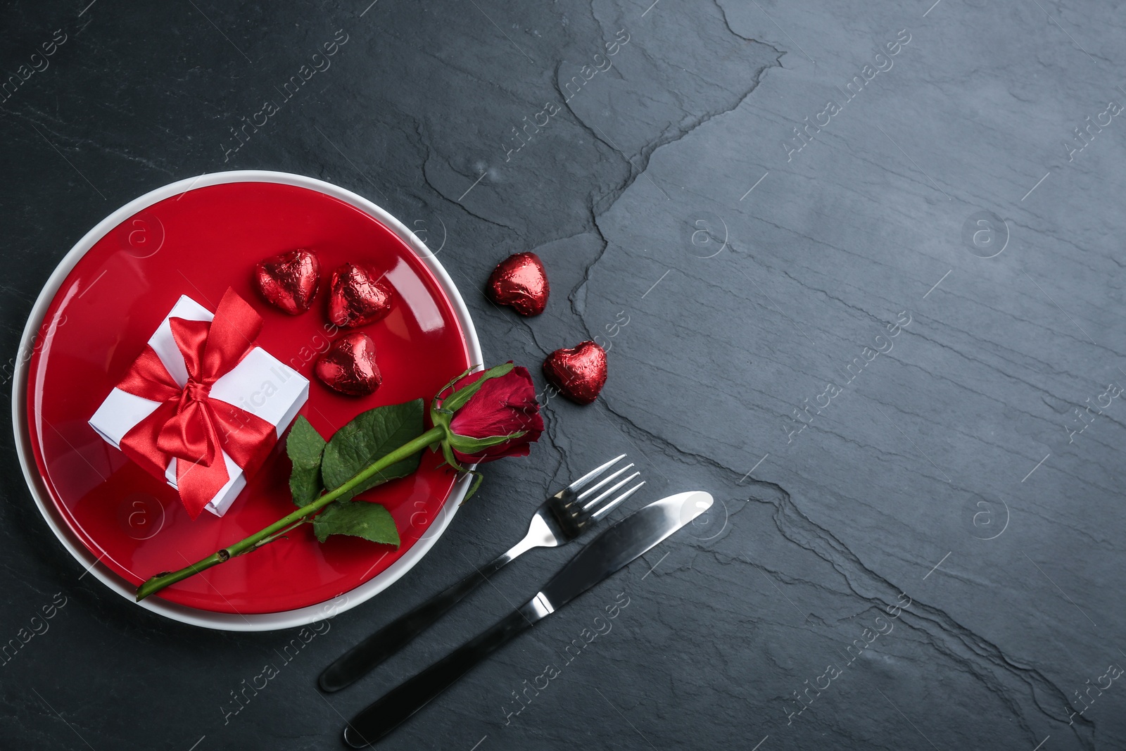 Photo of Beautiful table setting on black background, flat lay with space for text. Valentine's Day dinner