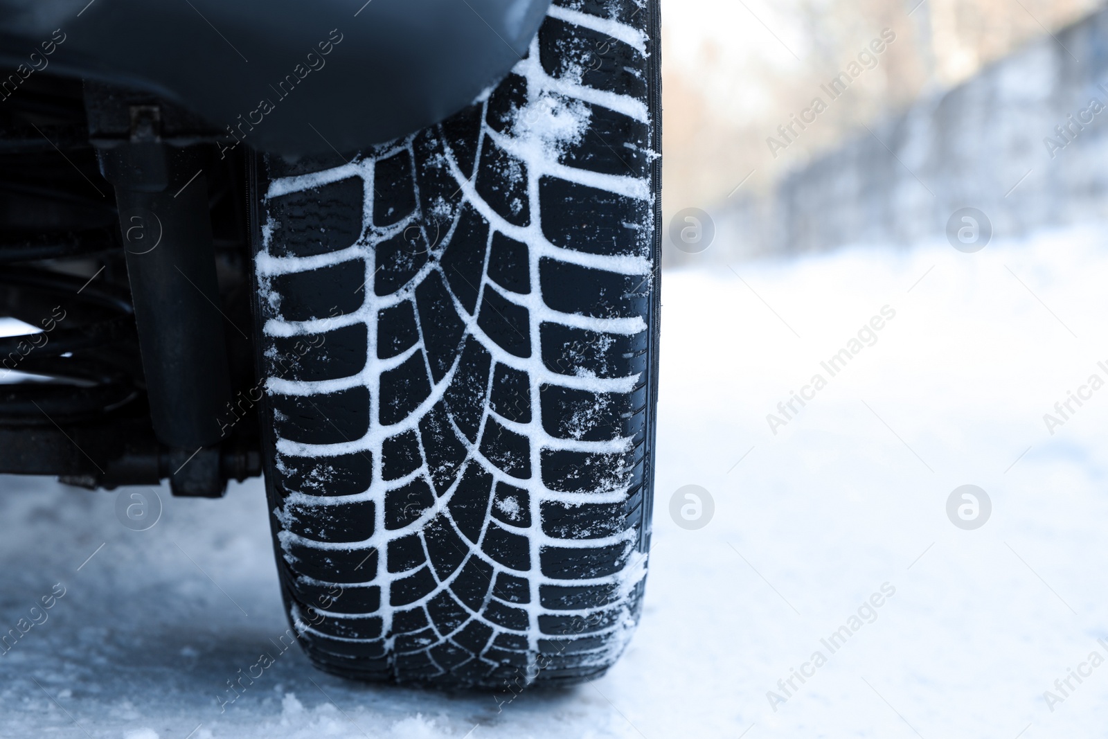 Photo of Car with winter tires on snowy road, closeup view