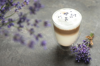 Photo of Delicious latte with lavender on grey table