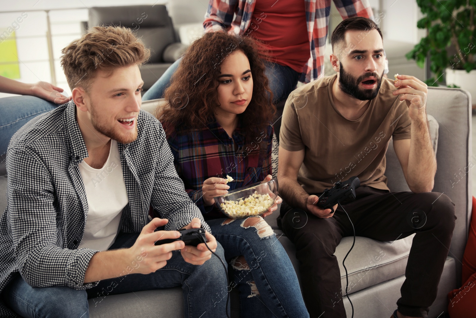 Photo of Emotional friends playing video games at home