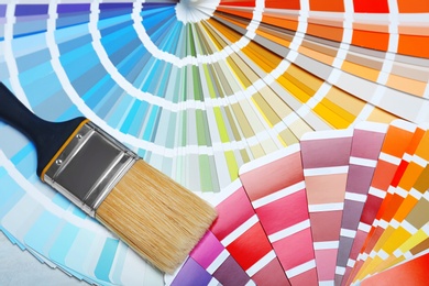 Photo of Closeup view of brush and paint color palette samples