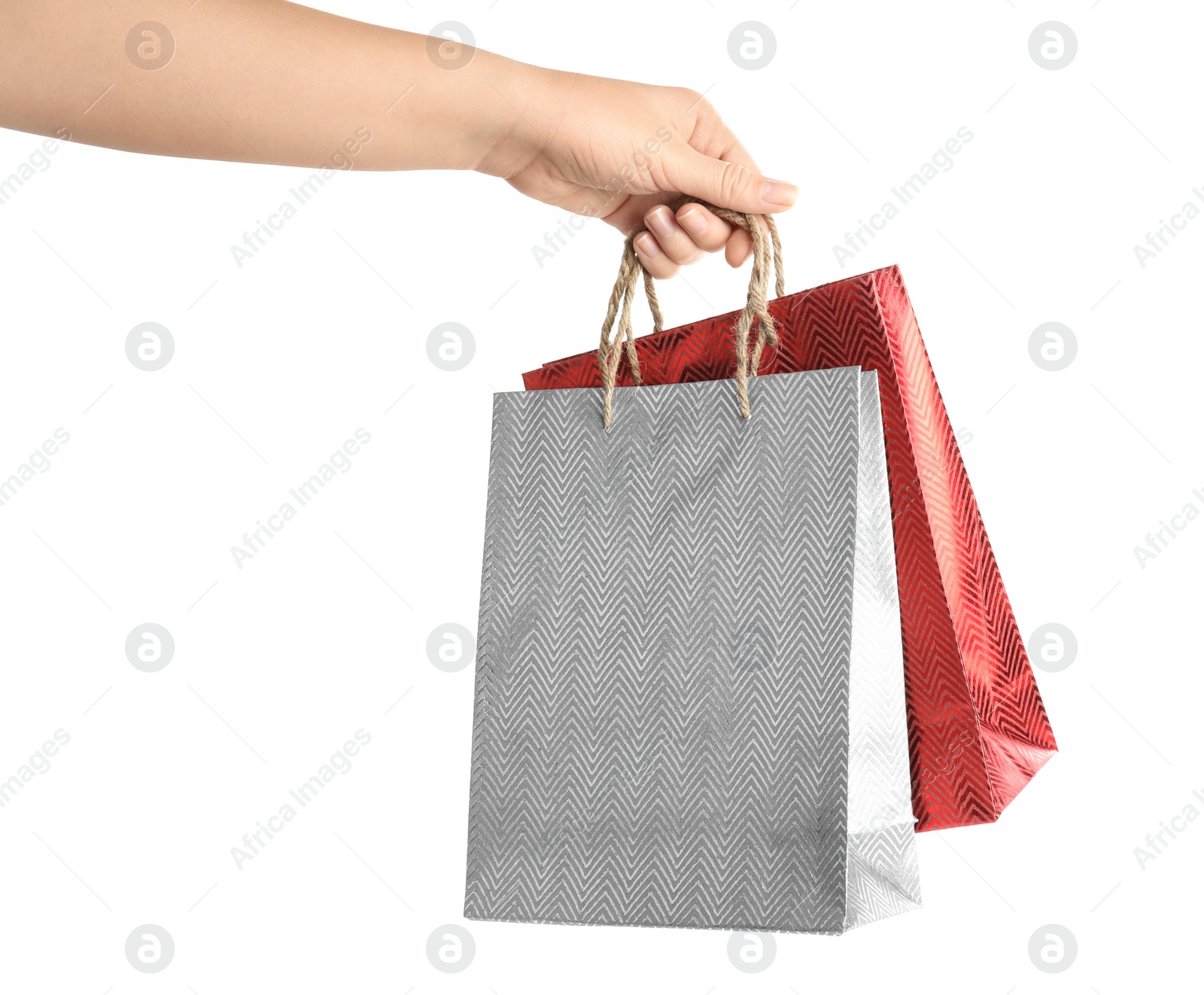 Photo of Woman holding paper shopping bags on white background, closeup. Space for design