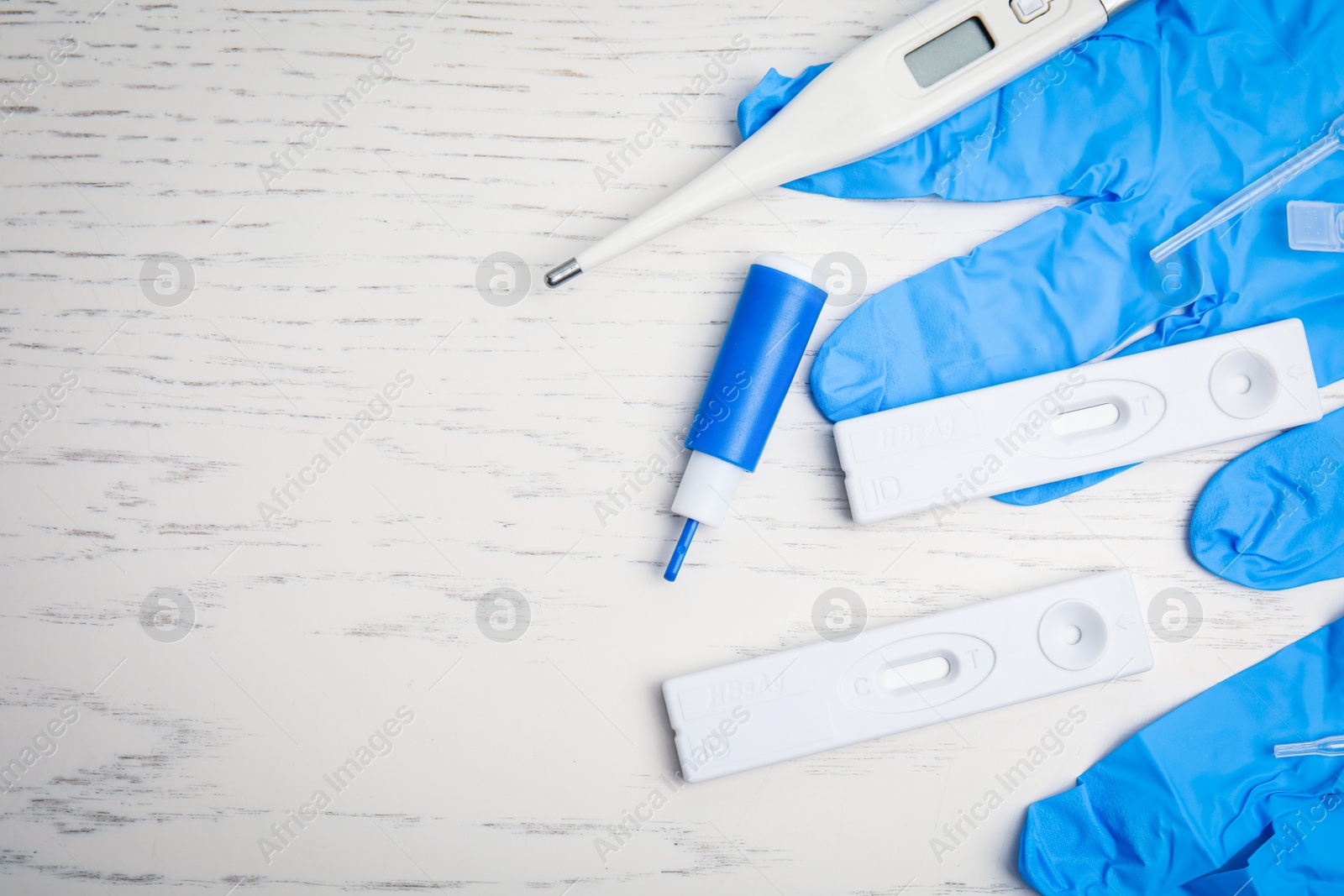 Photo of Disposable express hepatitis test kit on white wooden table, flat lay. Space for text