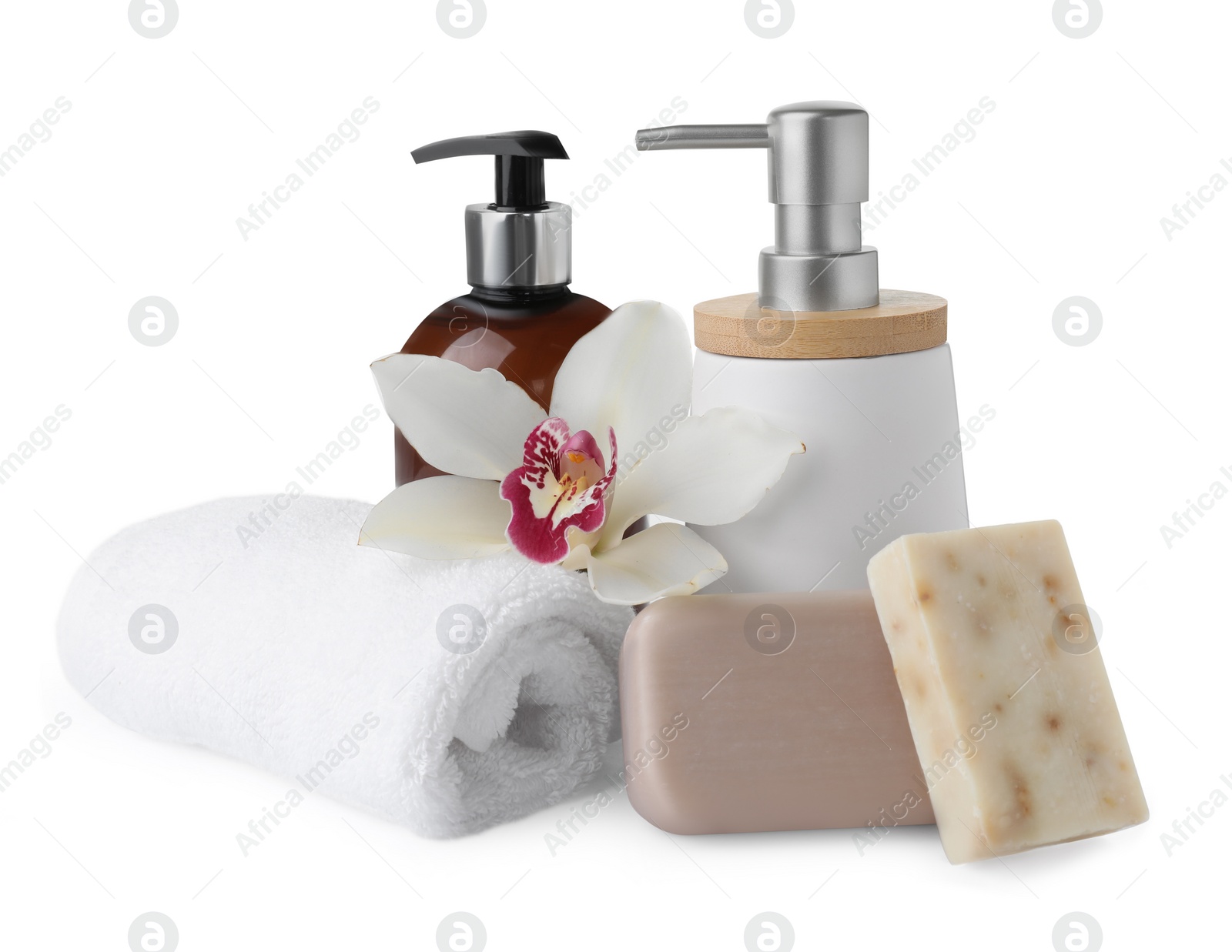 Photo of Soap bars, dispensers and terry towel on white background