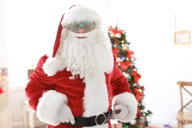 Authentic Santa Claus with funny glasses indoors