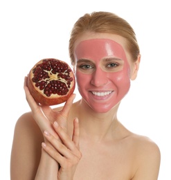 Photo of Young woman with pomegranate face mask and fresh fruit on white background