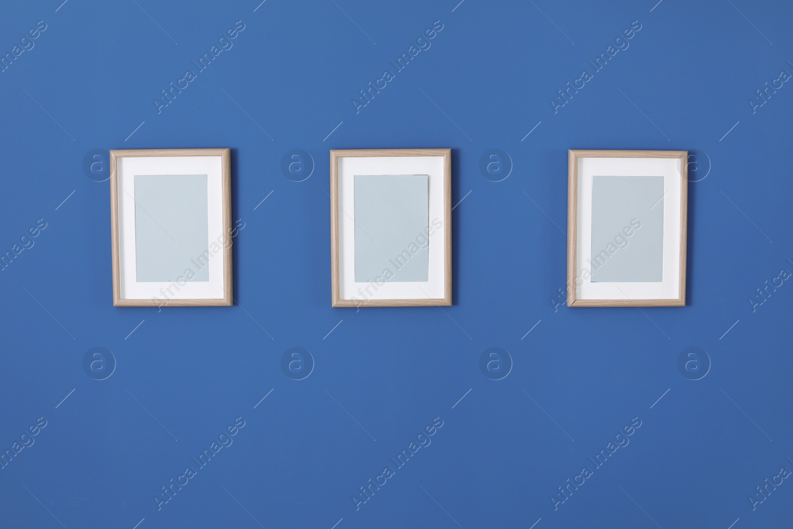 Photo of Empty frames on color wall