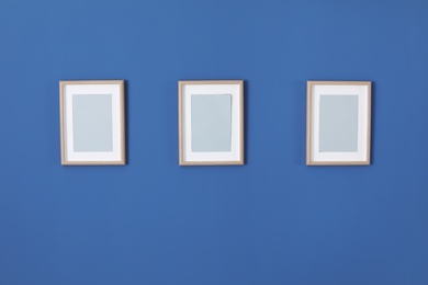 Photo of Empty frames on color wall